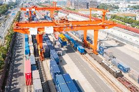 Workers Load Containers onto Vehicles in Nanjing