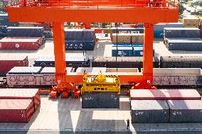 Workers Load Containers onto Vehicles in Nanjing