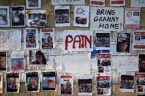 A wall covered with photographs of some of those taken hostage by Hamas