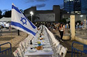 Familiies of Israelis held hostage by Hamas militants in Gaza set a shabbat table with more than 200 empty seats for the hostage