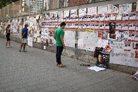 Israelis stand in front of photographs of some of those taken hostage by Hamas during their recent attacks