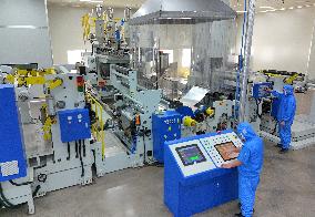 Workers Control Equipment At A Workshop in Yantai