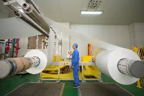 Workers Control Equipment At A Workshop in Yantai