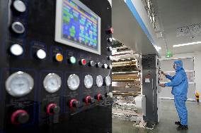 Workers Control Equipment At A Workshop in Yantai
