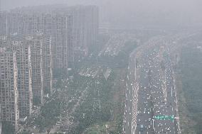 Buildings Loom Under Heavy Fog in Nanjing