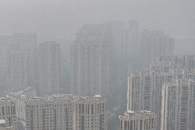 Buildings Loom Under Heavy Fog in Nanjing