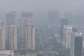 Buildings Loom Under Heavy Fog in Nanjing