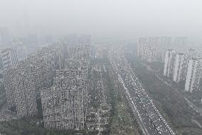 Buildings Loom Under Heavy Fog in Nanjing