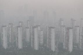 Buildings Loom Under Heavy Fog in Nanjing