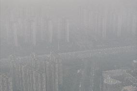 Buildings Loom Under Heavy Fog in Nanjing