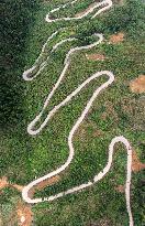 A Car Driving Along A Winding Country Road in Neijiang