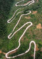 A Car Driving Along A Winding Country Road in Neijiang