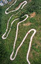 A Car Driving Along A Winding Country Road in Neijiang