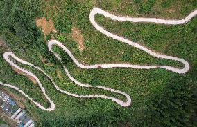 A Car Driving Along A Winding Country Road in Neijiang