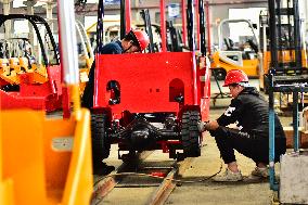 Workers Assembles Electric Forklift Trucks in Qingzhou