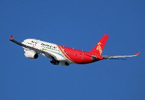 Shenzhen Airlines Airbus with Creative Fashion Capital livery taking off from Barcelona