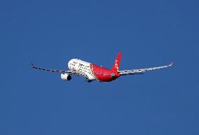 Shenzhen Airlines Airbus with Creative Fashion Capital livery taking off from Barcelona