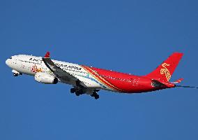 Shenzhen Airlines Airbus with Creative Fashion Capital livery taking off from Barcelona