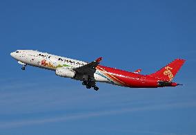 Shenzhen Airlines Airbus with Creative Fashion Capital livery taking off from Barcelona