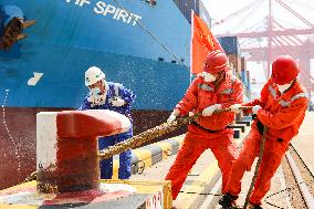 Workers Pull A Cable at Zhenghe International Terminal in Suzhou