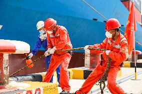 Workers Pull A Cable at Zhenghe International Terminal in Suzhou