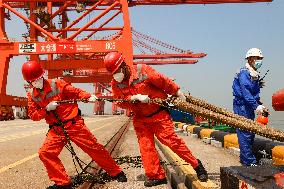 Workers Pull A Cable at Zhenghe International Terminal in Suzhou