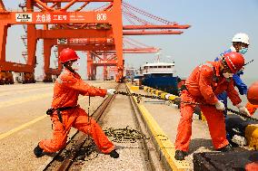 Workers Pull A Cable at Zhenghe International Terminal in Suzhou