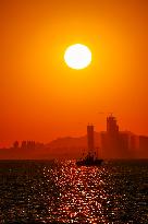 Fishing Boats Sailing at Sunset in Qingdao