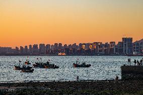 Fishing Boats Sailing at Sunset in Qingdao