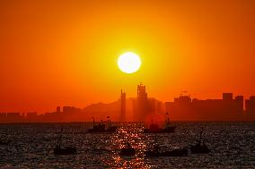 Fishing Boats Sailing at Sunset in Qingdao