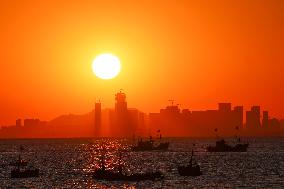 Fishing Boats Sailing at Sunset in Qingdao