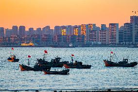 Fishing Boats Sailing at Sunset in Qingdao