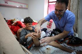 Injured Palestinian at Shuhada al-Aqsa Hospital Amidst Gaza-Israel Conflict