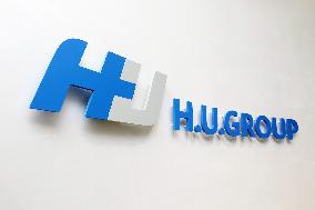 H.U. Group Holdings signage and logo