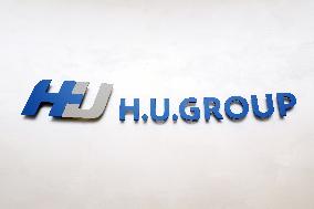 H.U. Group Holdings signage and logo