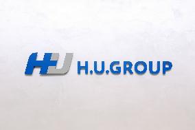 H.U. Group Holdings signage and logo