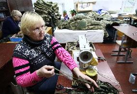 Kyiv Region volunteers make camouflage nets and uniforms for Ukrainian military