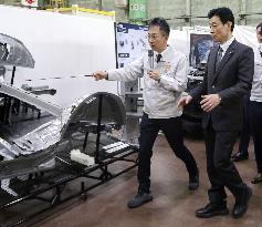 Economy minister Nishimura visits Toyota factory