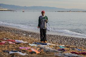 Staging Of An Migrant Shipwreck On A Beach In Barcelona.