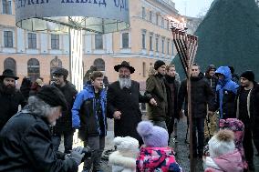 Lighting menorah candle in Odesa