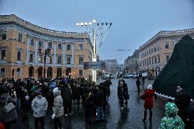 Lighting menorah candle in Odesa