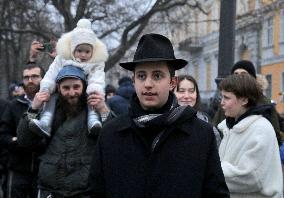 Lighting menorah candle in Odesa