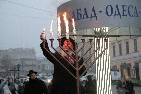 Lighting menorah candle in Odesa