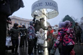 Lighting menorah candle in Odesa