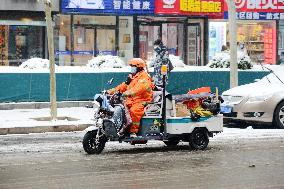 A Courier Rides During Heavy Snow in Beijing