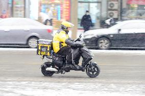 A Courier Rides During Heavy Snow in Beijing