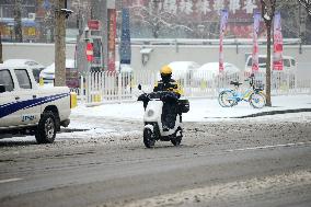 A Courier Rides During Heavy Snow in Beijing