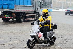 A Courier Rides During Heavy Snow in Beijing