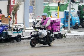 A Courier Rides During Heavy Snow in Beijing