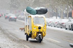 A Courier Rides During Heavy Snow in Beijing